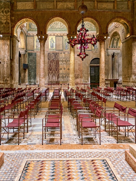 Tourists inside St. Mark's Basilica admiring its architecture, Venice, Italy.