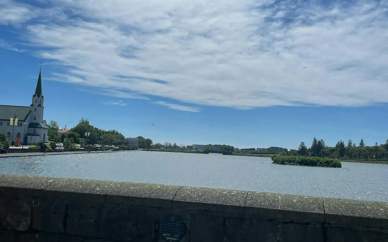 Tjörnin lake with Fríkirkjan church in Reykjavik, part of the self-guided city exploration game.