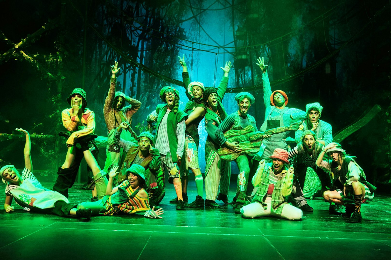 Performers in colorful costumes on stage during "Peter, El Musical" show.