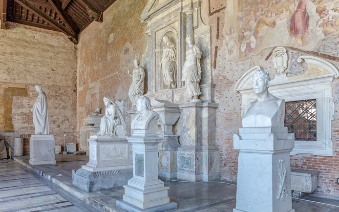 Sculptures inside Pisa Camposanto at Pisa Cathedral Square.