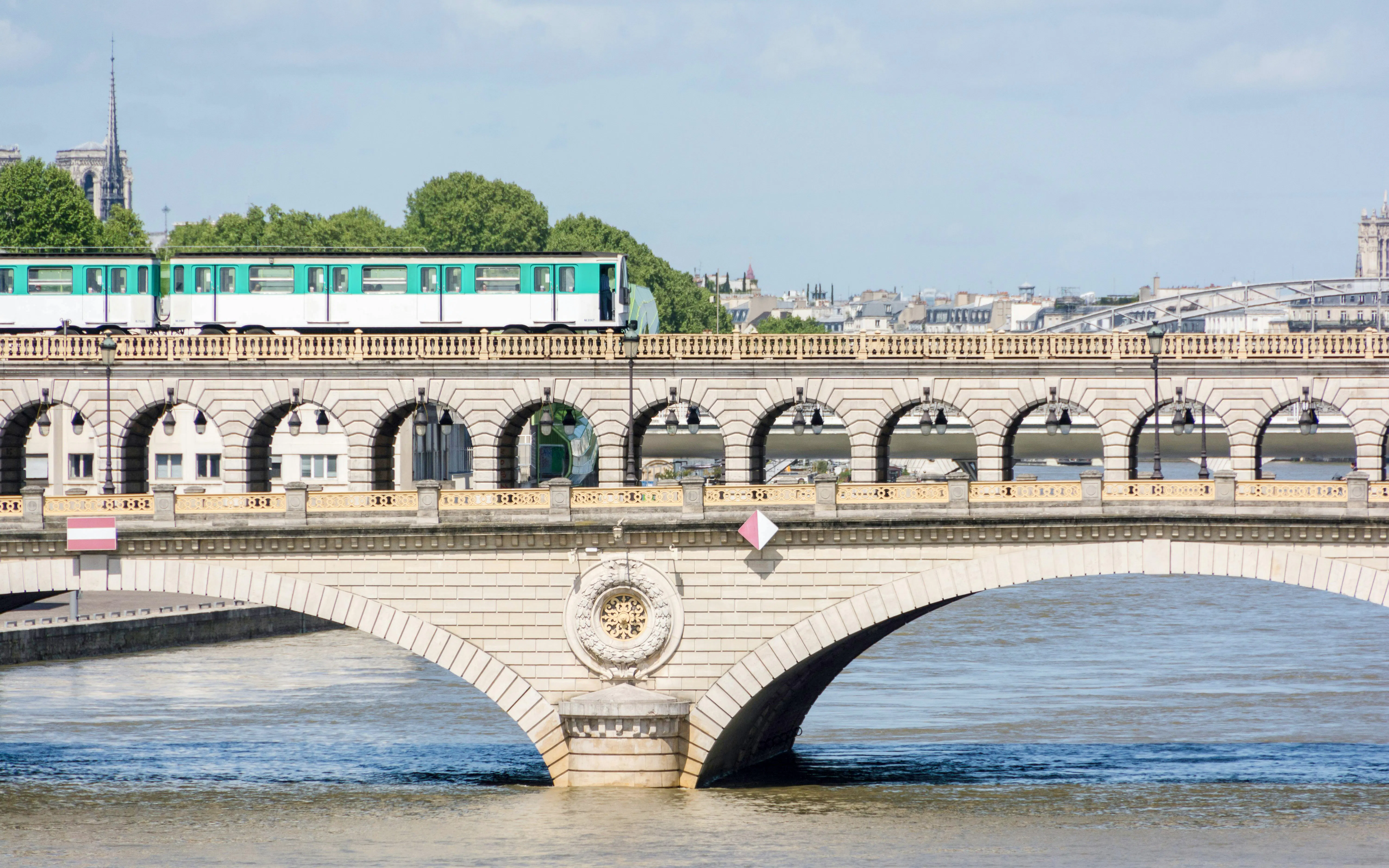 Subway train crossing Pont de Bir-Hakeim bridge in Paris.