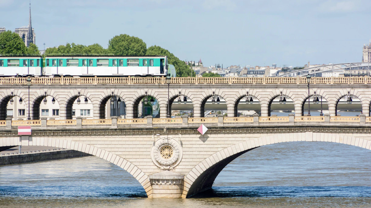 Subway train crossing Pont de Bir-Hakeim bridge in Paris.