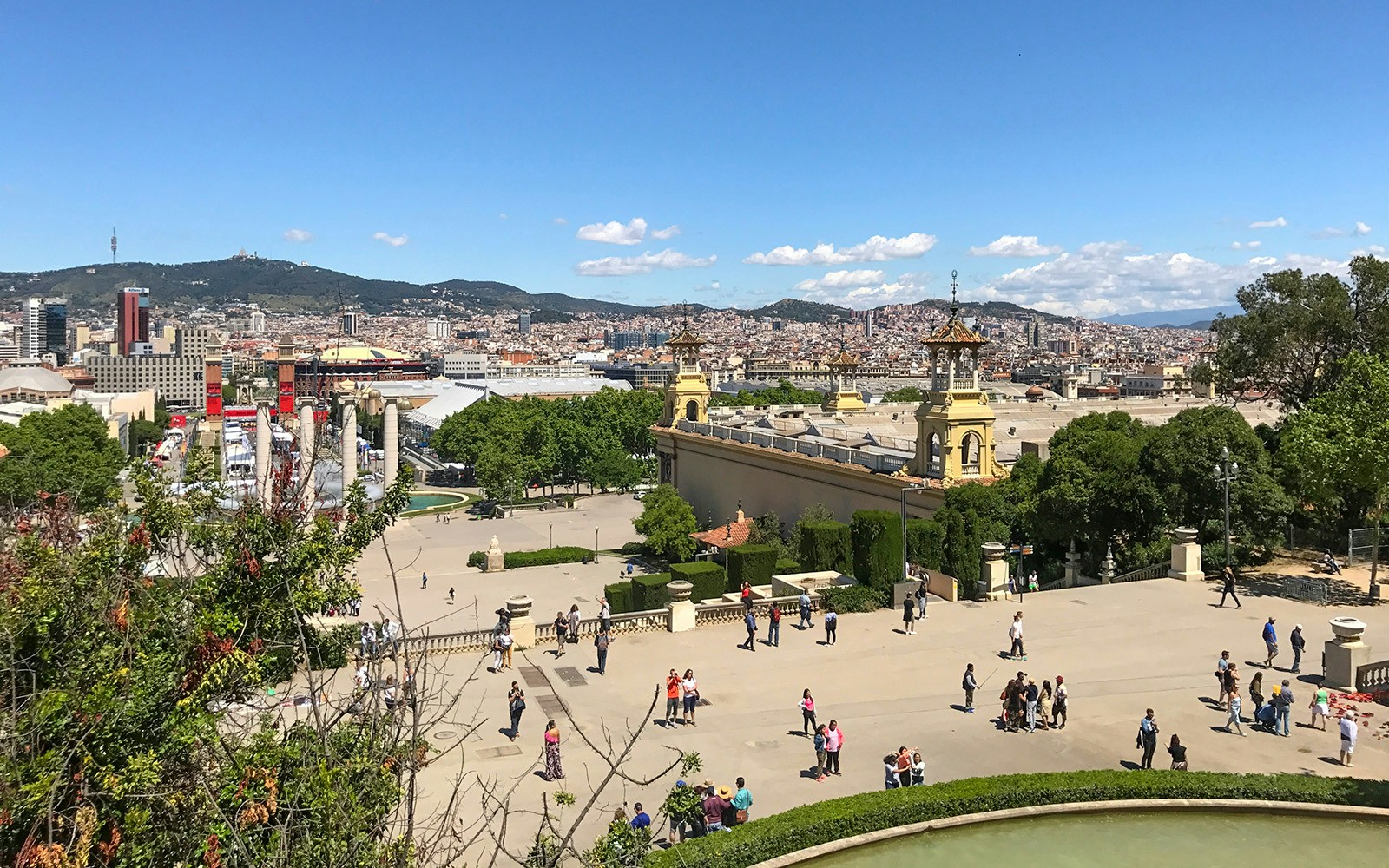 Cable car ascending Parc de Montjuic, Barcelona, with cityscape and Mediterranean Sea in the background.