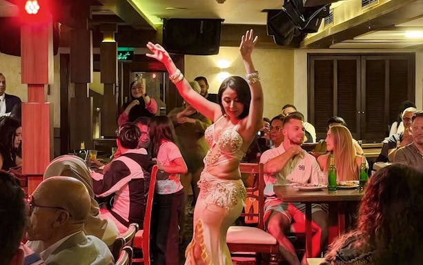 Belly dance performer entertaining guests on a 4-Star Nile dinner cruise.