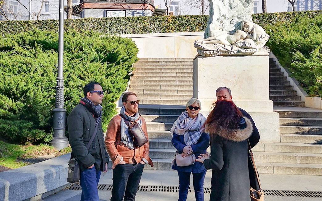 Group listening to guide at Prado Museum entrance, Madrid.