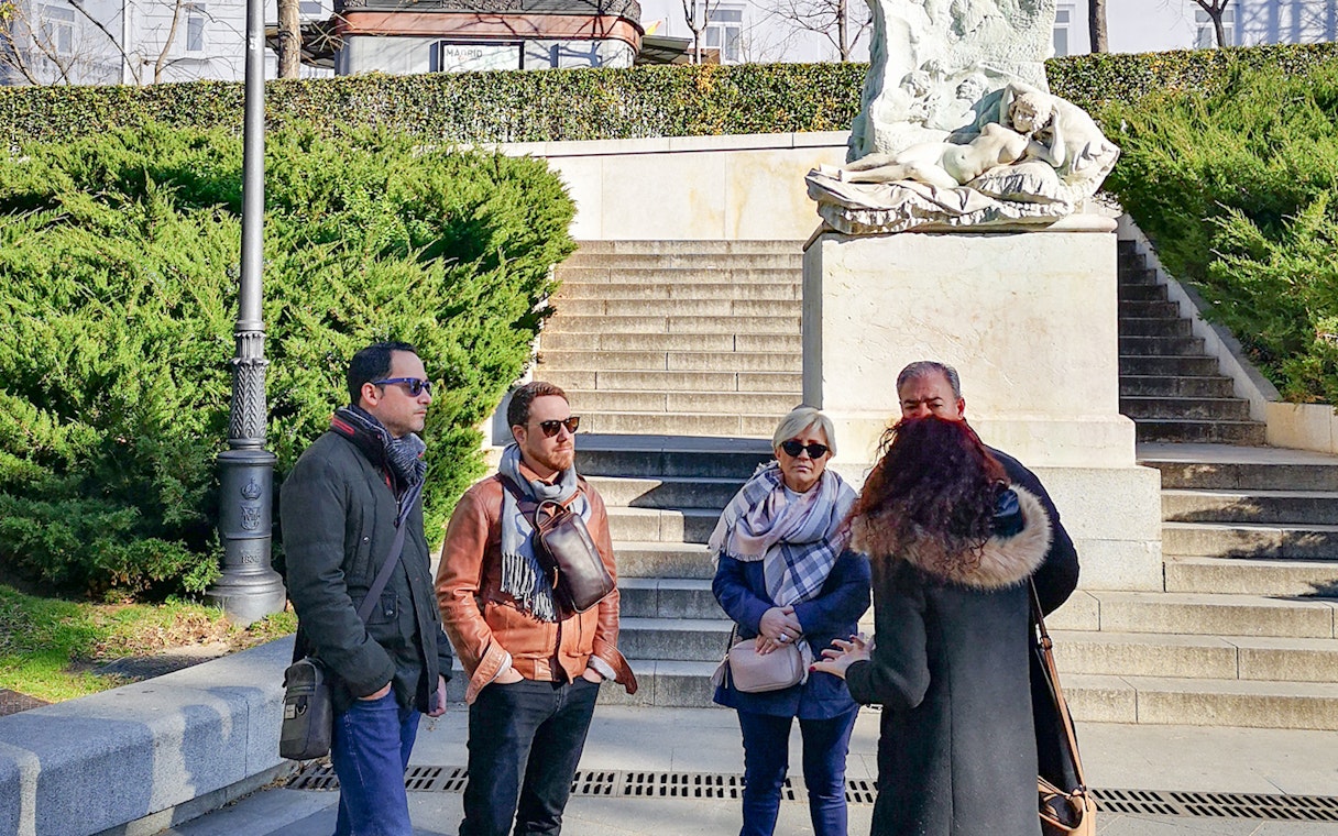 Group listening to guide at Prado Museum entrance, Madrid.