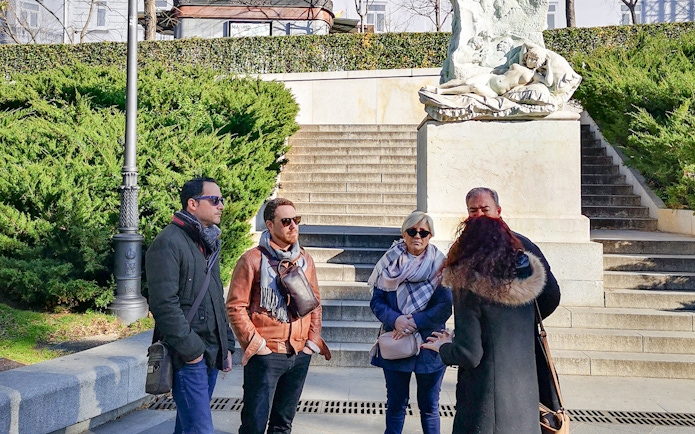 Group listening to guide at Prado Museum entrance, Madrid.