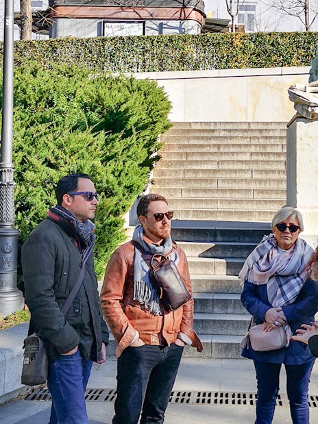 Group listening to guide at Prado Museum entrance, Madrid.
