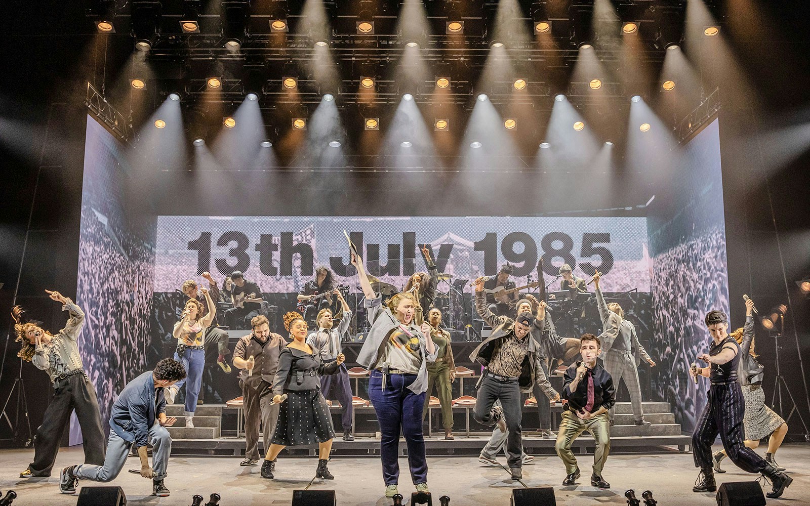 Performers on stage at Just for One Day show, backdrop reads "13th July 1985".