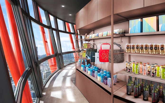 Gift shop inside Kobe Port Tower with city view through curved windows.
