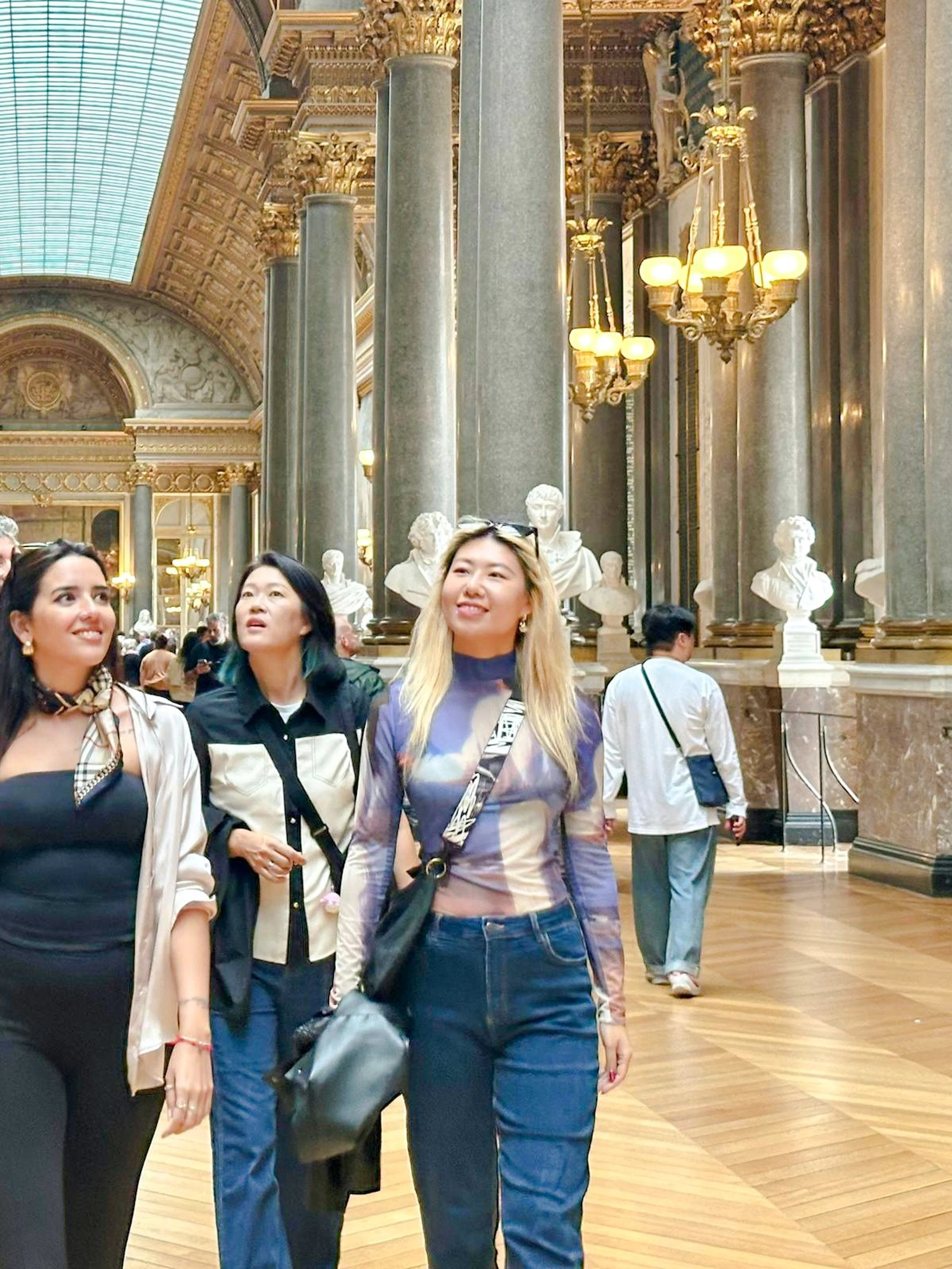 Visitors exploring the Hall of Mirrors on a Versailles guided tour.