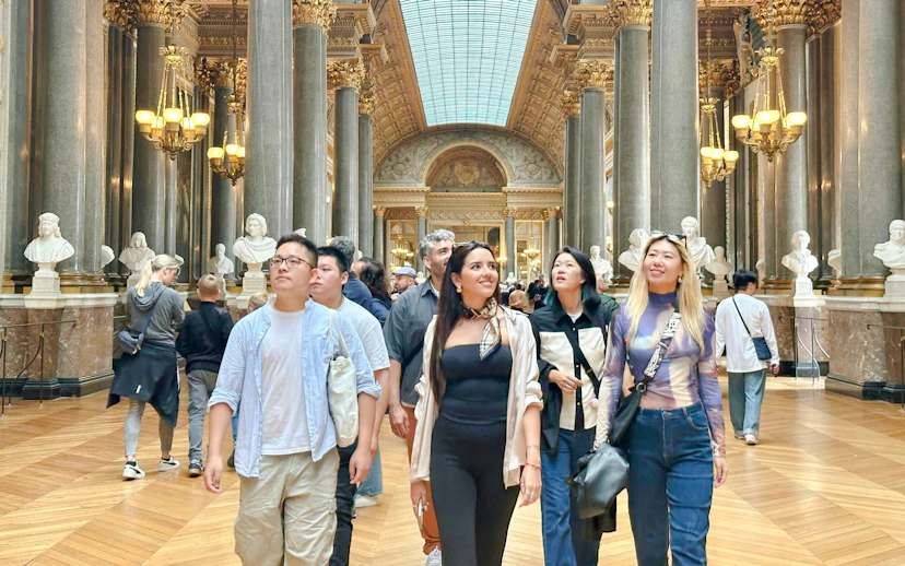 Visitors exploring the Hall of Mirrors on a Versailles guided tour.