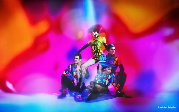Performers in colorful costumes at BLINDED by DELIGHT Grand Show, Friedrichstadt Palast.