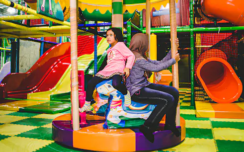 Children playing on a carousel at Jungle Gym, KL East Mall, Malaysia.