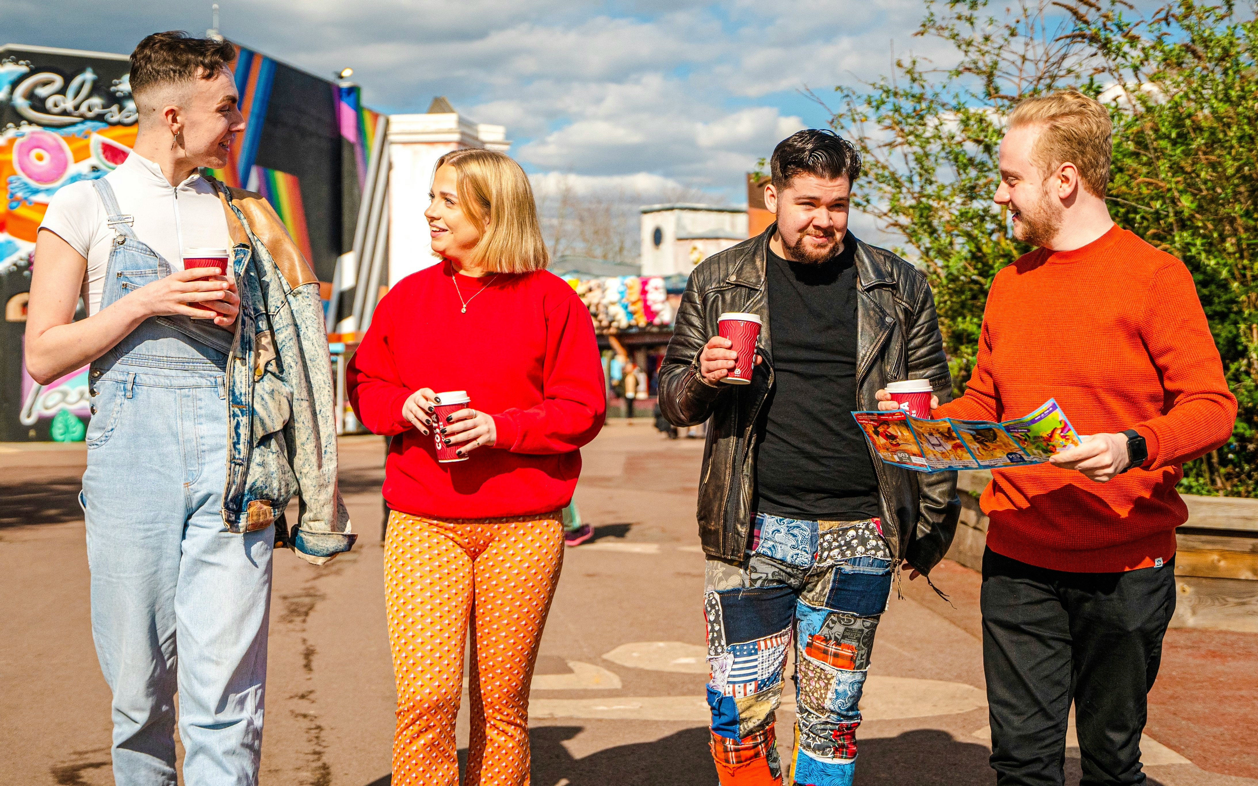 Guests enjoying drinks and a map at Thorpe Park London.
