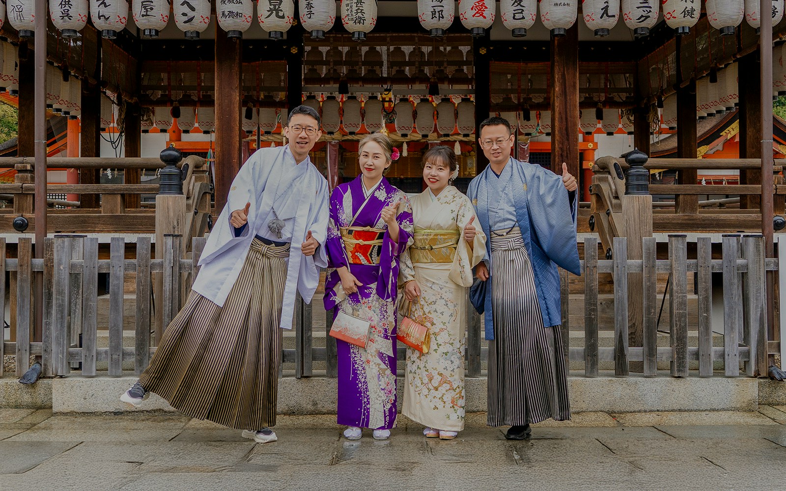 Group wearing kimonos in front of a Kyoto shrine.