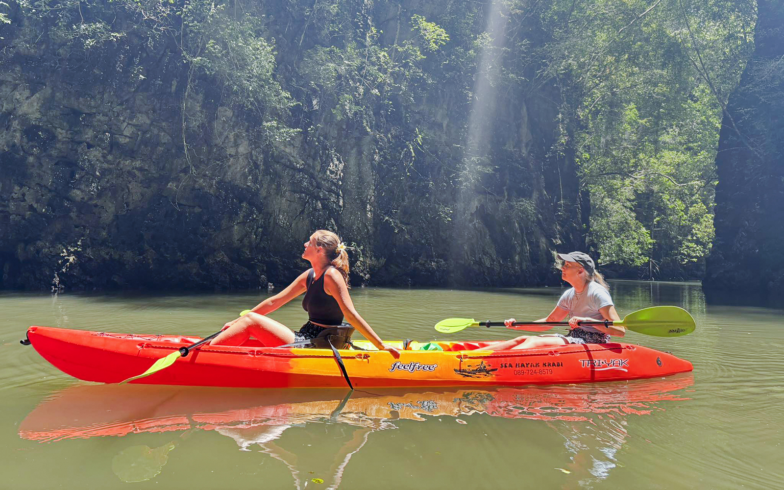 Tourists kayaking through Ao Thalane mangrove forests in Krabi, Thailand.