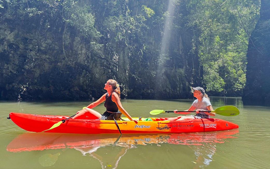 Tourists kayaking through Ao Thalane mangrove forests in Krabi, Thailand.