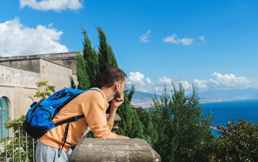 Traveller viewing Naples from Certosa di San Martino terrace, Italy.
