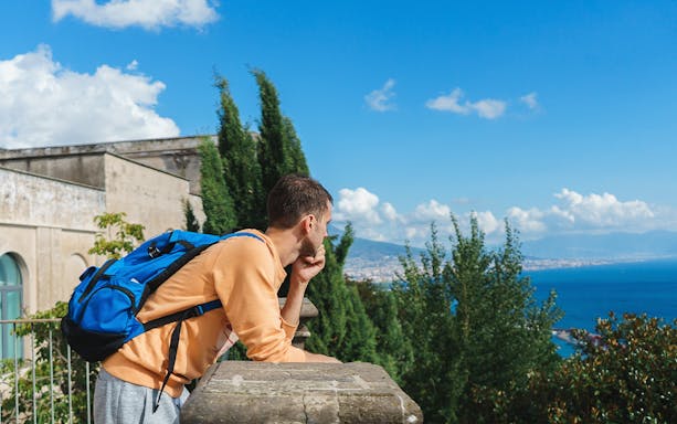 Traveller viewing Naples from Certosa di San Martino terrace, Italy.