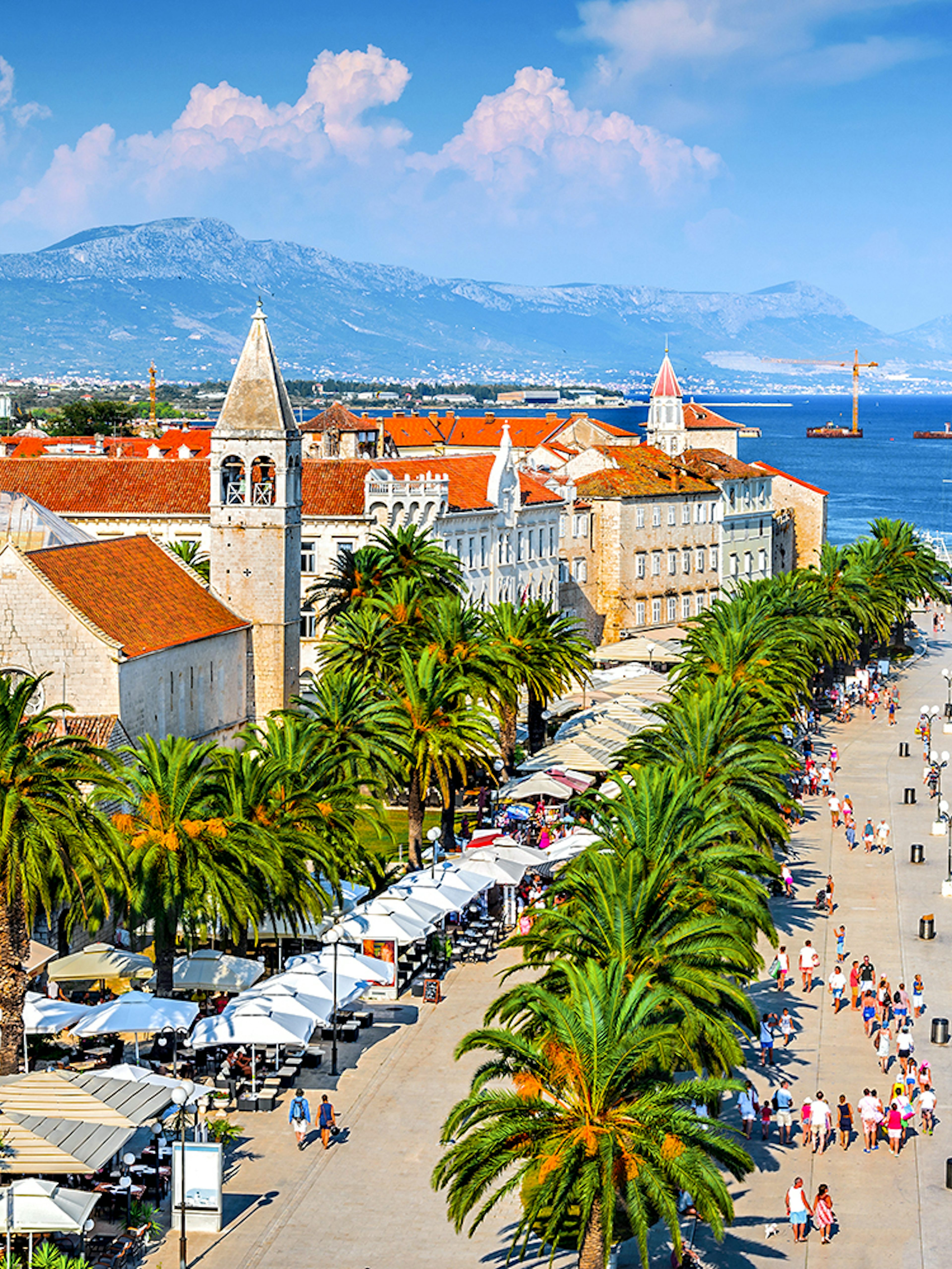Aerial view of Trogir, Croatia, featuring historic buildings and waterfront promenade.
