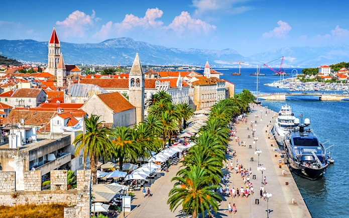 Aerial view of Trogir, Croatia, featuring historic buildings and waterfront promenade.