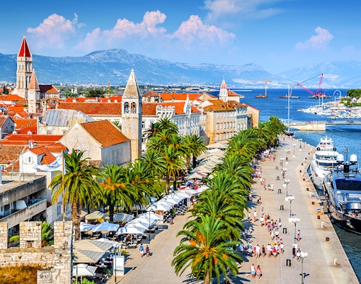 Aerial view of Trogir, Croatia, featuring historic buildings and waterfront promenade.