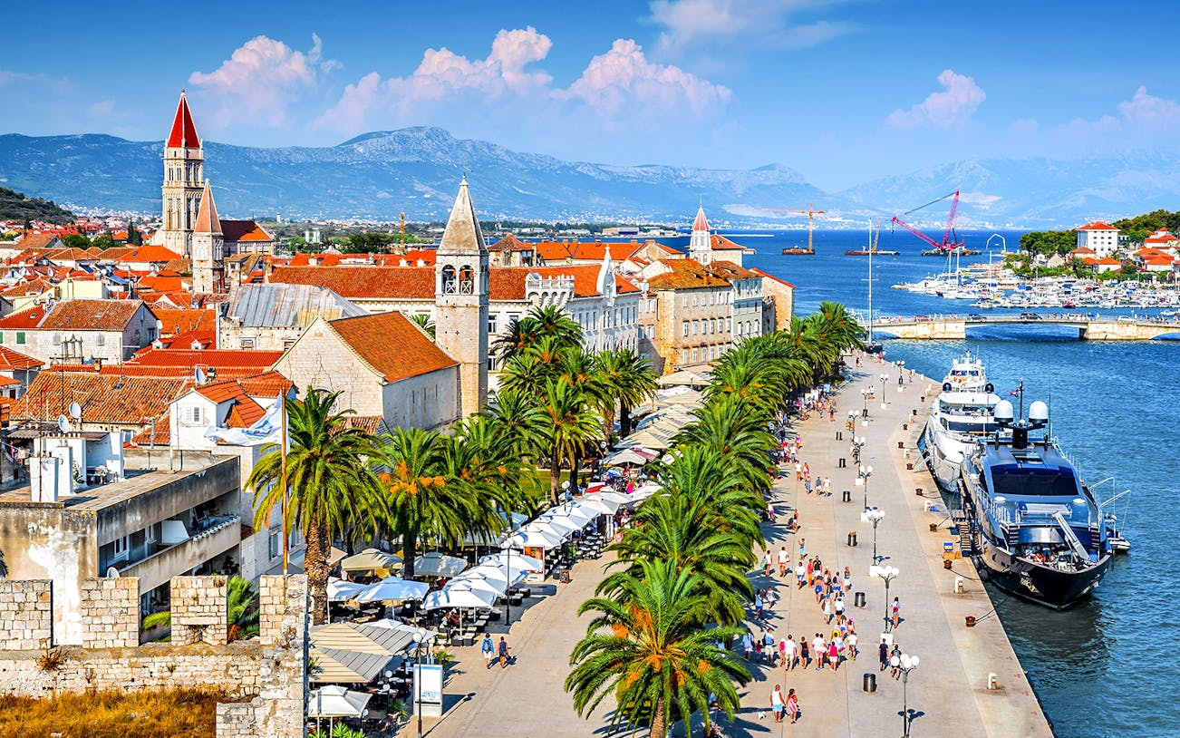 Aerial view of Trogir, Croatia, featuring historic buildings and waterfront promenade.