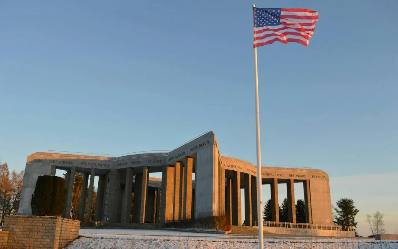 Mardasson Memorial with American flag, Bastogne, part of Battle of the Bulge 80th Anniversary Tour.
