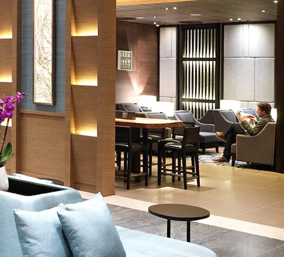 Plaza Premium Lounge seating area at London Heathrow Airport with modern decor.