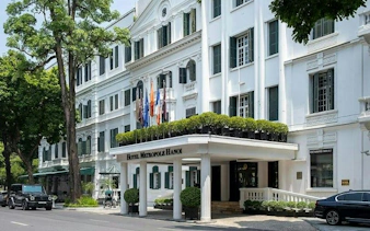 Hotel Metropole Hanoi exterior in the Old Quarter, part of the self-guided city exploration game.