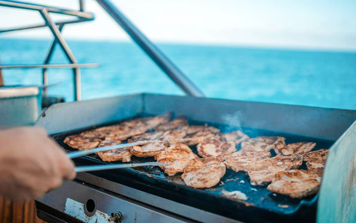 Barbeque grill with chicken on Alanya Boat Day Tour.
