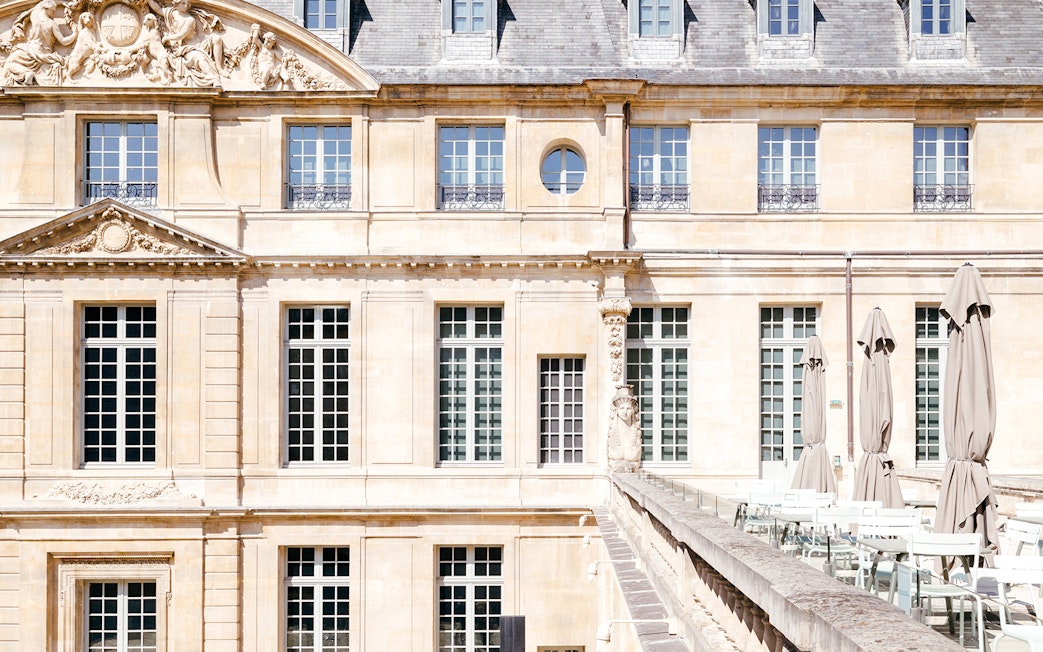 Picasso Museum terrace cafe with closed umbrellas, Paris, France.