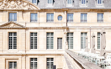 Picasso Museum terrace cafe with closed umbrellas, Paris, France.