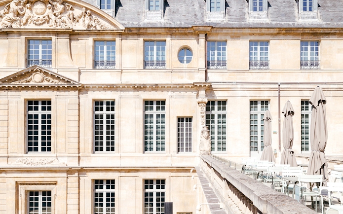 Picasso Museum terrace cafe with closed umbrellas, Paris, France.