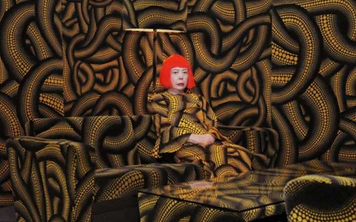 Yayoi Kusama installation at Stedelijk Museum Amsterdam with patterned walls and furniture.
