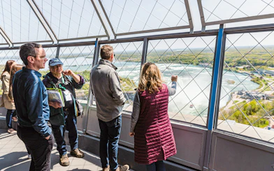 Tourists viewing Horseshoe Falls from Skylon Tower observation deck.