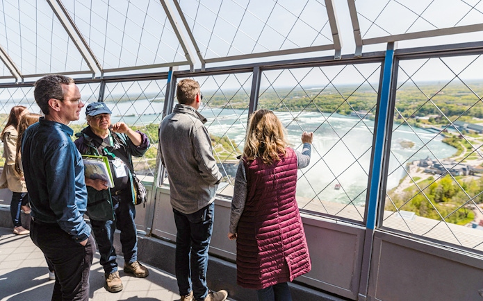 Tourists viewing Horseshoe Falls from Skylon Tower observation deck.