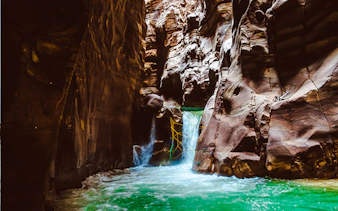 Wadi Mujib Siq Trail waterfall and canyon walls, Amman adventure hike.