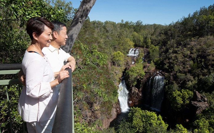 Couple enjoying waterfall view at Litchfield National Park, Darwin day tour.