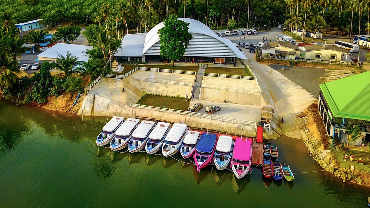 Speed boats docked at a pier in Phuket for Similan Islands full day tour.