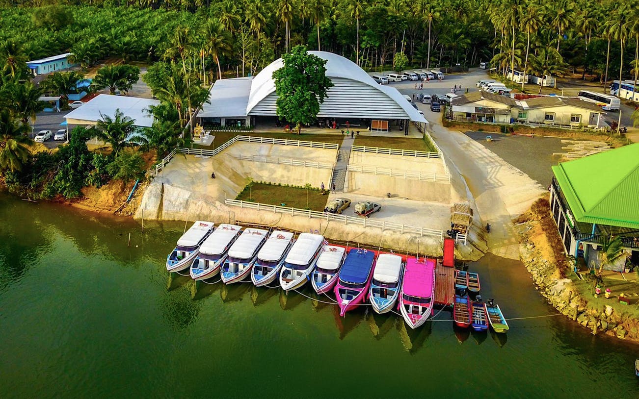 Speed boats docked at a pier in Phuket for Similan Islands full day tour.
