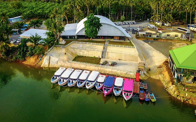 Speed boats docked at a pier in Phuket for Similan Islands full day tour.