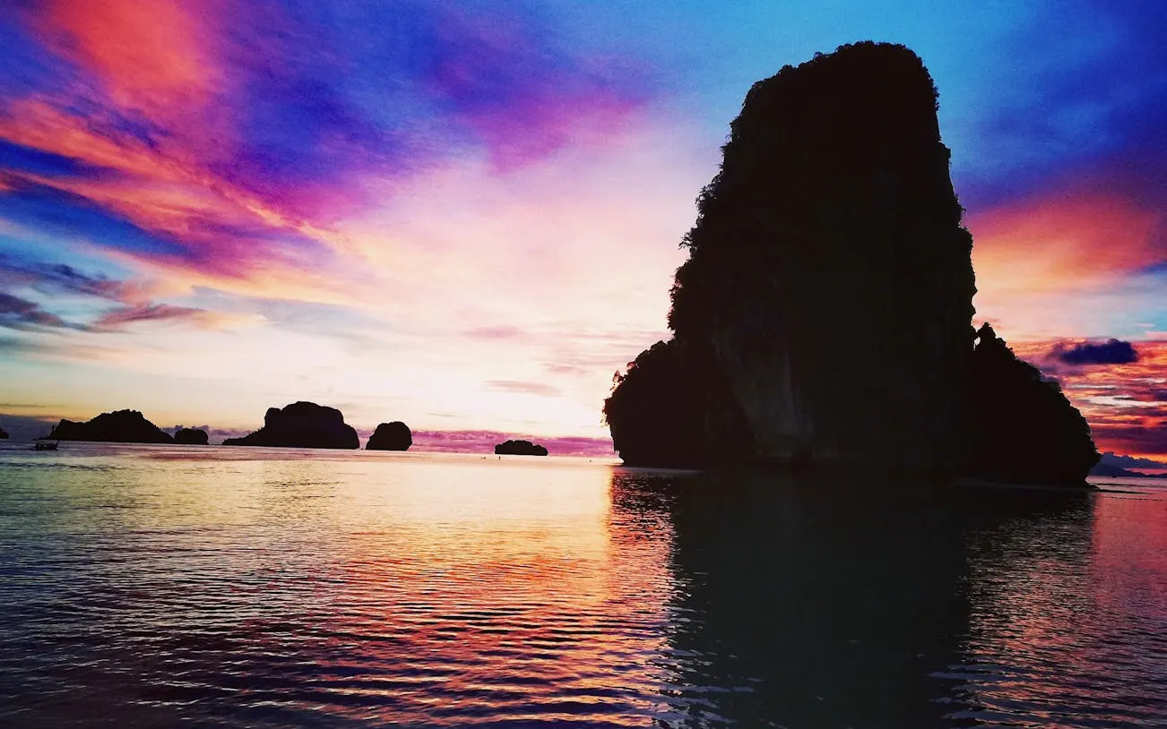 Sunset view of limestone islands in Krabi during a speedboat tour.