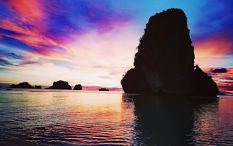 Sunset view of limestone islands in Krabi during a speedboat tour.