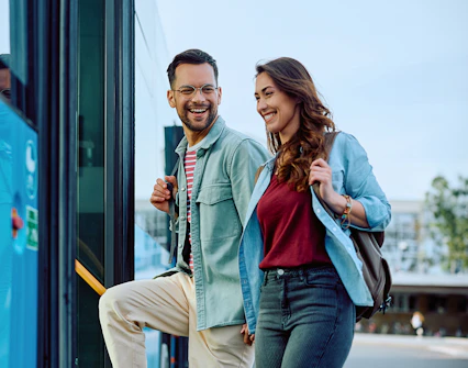 Couple boarding Aerobus in Barcelona city center for airport transfer.