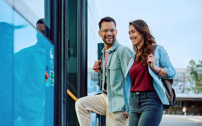 Couple boarding Aerobus in Barcelona city center for airport transfer.