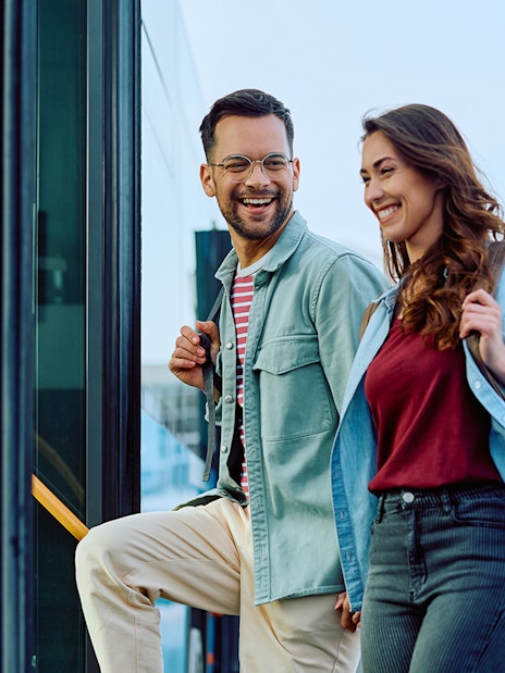Couple boarding Aerobus in Barcelona city center for airport transfer.