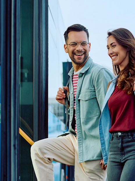 Couple boarding Aerobus in Barcelona city center for airport transfer.