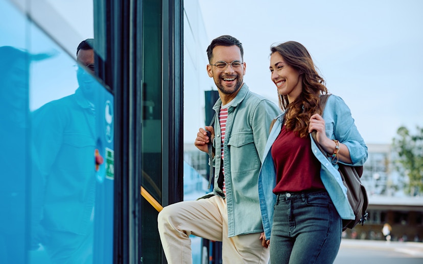 Couple boarding Aerobus in Barcelona city center for airport transfer.